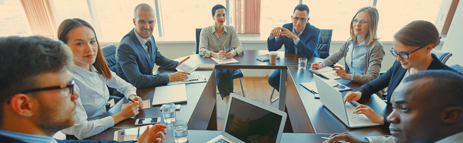 People in a meeting surrounding a table